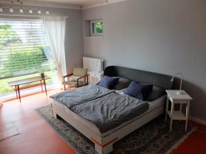 a bedroom with a bed in a room with a window at Cozy Place in Müllendorf