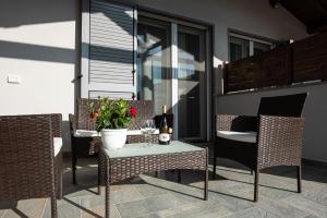 a patio with a table and chairs on a balcony at Residence Pace & Relax in Marina di Grosseto