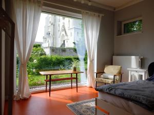 a bedroom with a bed and a table and a window at Cozy Place in Müllendorf