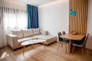 a living room with a couch and a table at Magdalena Suite 3.0 in Heraklio +15 photos