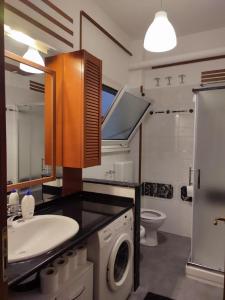 a bathroom with a sink and a washing machine at Casa Giò in Lido di Ostia