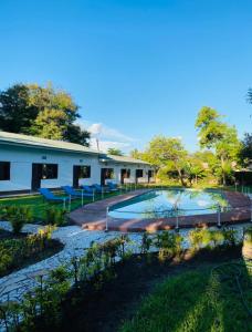 a house with a swimming pool in the yard at Fig Tree Lodge Camp in Mto wa Mbu
