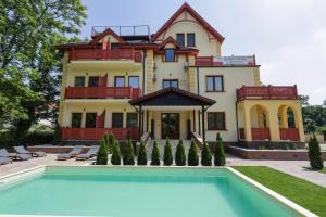 a large house with a pool in front of it at ETA 2 APARTMENT in Palić