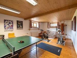 a living room with a ping pong table in it at Ferienwohnungen Haus Schwaiger in Fieberbrunn