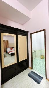 a bedroom with a bed and a mirror at Saigon PT Hotel in Ấp Bình Hưng