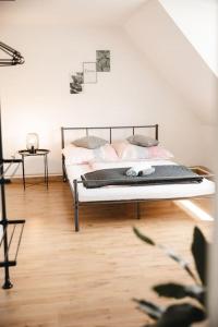a bedroom with a bed and a wooden floor at Modernes Apartment Schwarzenfeld in Schwarzenfeld