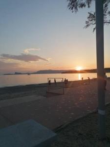 a group of people on a beach at sunset at Proche de la plage les hauts du port in Saint-Cyr-sur-Mer