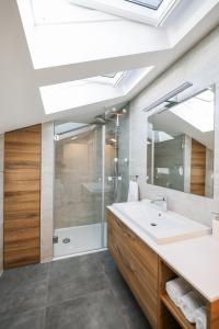 a bathroom with a sink and a shower and a mirror at Apartman Fortuna in Zadar