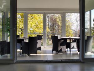 - une salle à manger avec une table, des chaises et des fenêtres dans l'établissement Rekreačné zariadenie Crocus, à Vysoké Tatry