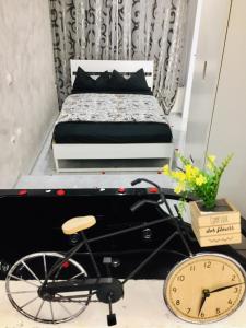 a bedroom with a bed and a bicycle in front of it at Le rocce nere in Giardini Naxos