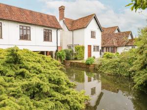 a row of white houses next to a river at Shore Hall in Braintree