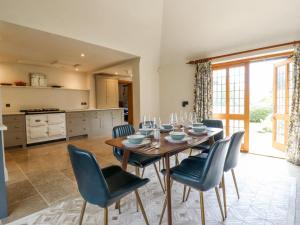 a kitchen and dining room with a table and chairs at Shore Hall in Braintree