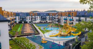 an apartment complex with a water park with a playground at Bel mare aqua 2 Aquapark in Międzyzdroje