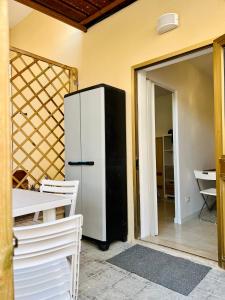 a black and white refrigerator in a room at Mini villino Ladispoli Centro Mare in Ladispoli