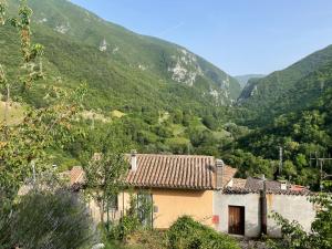a house in a valley with mountains in the background at Casalino 