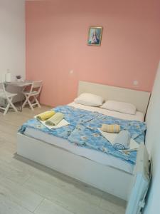 a bed with a blue comforter in a bedroom at Rooms Mario in Međugorje