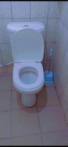 a bathroom with a white toilet in a stall at La Cité des Anges in Nkongsamba