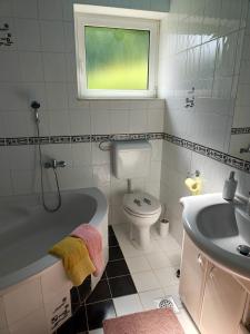 a bathroom with a tub and a toilet and a sink at Apartma Nena in Bovec +24 photos