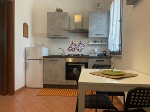 a kitchen with a white refrigerator and a table at Casalino 