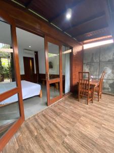 a room with a table and a bed and a dining room at Rama Village in Canggu