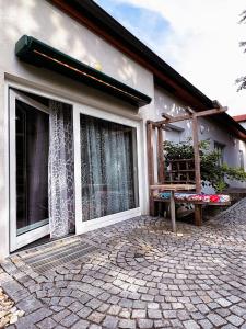 a house with windows and a bench in front of it at Apartment-Oberlaa in Vienna