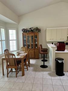 a kitchen and dining room with a table and chairs at Grandma’s White House in Palm Coast