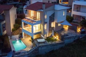 an aerial view of a house with a swimming pool at SUNRISE LUXURY POOL VILLA in Paleo Tsifliki