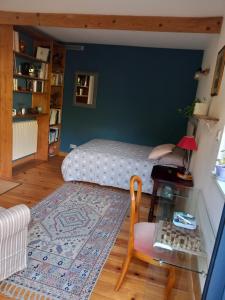 a living room with a bed and a table at Chez Anne in Rennes