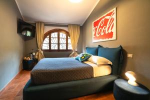 a bedroom with a bed and a couch and a window at La Sosta in Toscana in Camaiore