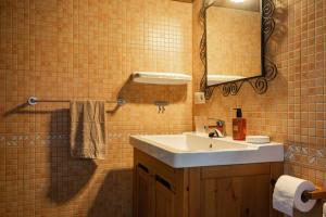 a bathroom with a sink and a mirror at Casa escondida cuencu in Margolles +34 photos
