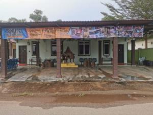 a building with awning in front of a house at Teratak Tuan Muda Homestay in Melaka