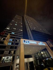 a tall building at night with its lights on at Antasya Residence 1+1 With Pool And High Floor in Istanbul