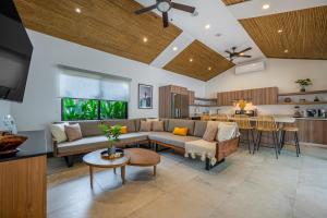 a living room with a couch and a table at Casa de Armonia in Tamarindo
