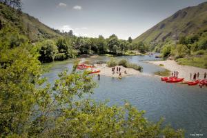 a group of people in boats on a river at Hotel Los Robles in Cangas de Onís