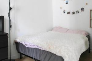 a bedroom with a bed with a blanket on it at A cosy little nest in the 5th arrondissement in Paris