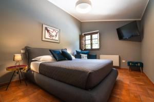 A bed or beds in a room at La Sosta in Toscana