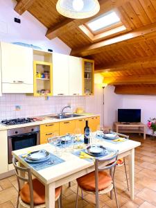 a kitchen with a table with two chairs and a sink at SUITE - Alessandra Holiday House in Piove di Sacco