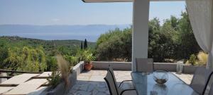 a table and chairs on a patio with a view at Aiolos in Kalamaki Messinia