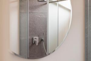 a mirror in a bathroom with a shower at Olmo Suites in Como