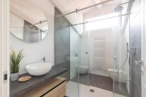 a bathroom with a sink and a mirror at Olmo Suites in Como