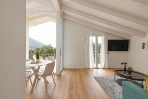 a living room with a table and a dining room at Olmo Suites in Como