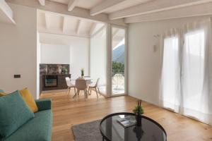 a living room with a green couch and a table at Olmo Suites in Como