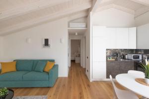 a living room with a blue couch and a table at Olmo Suites in Como