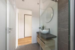 a bathroom with a sink and a mirror at Olmo Suites in Como
