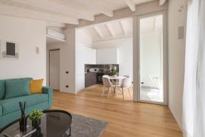 a living room with a blue couch and a table at Olmo Suites in Como