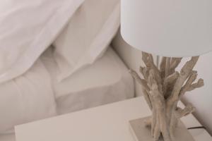 a lamp sitting on top of a white table at Olmo Suites in Como