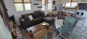 a living room with a couch and a chair at Aiolos in Kalamaki Messinia