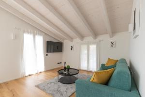 a living room with a blue couch and a table at Olmo Suites in Como