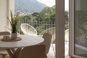 a white table and chairs on a balcony with a view at Olmo Suites in Como