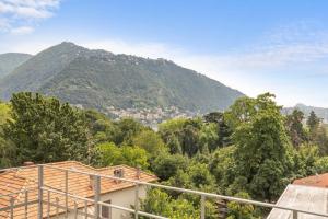 a view of a mountain from a house at Olmo Suites in Como